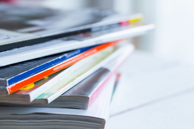 Pile of colorful magazines on a table