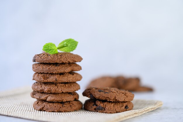 A pile of cookies on a cloth on a wooden table