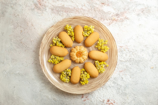 Pile of cookies on a plate with bright yellow flowers on a marble