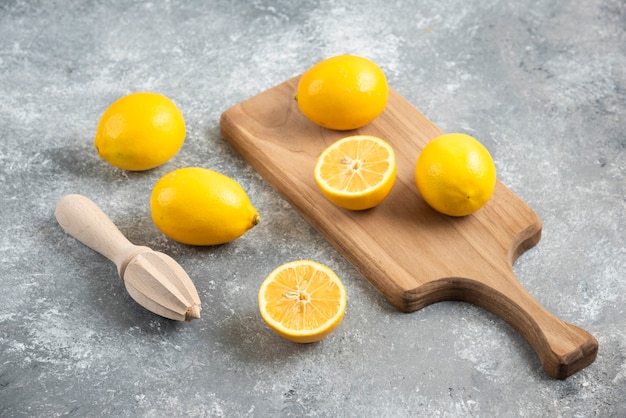 Fresh Sliced Citrus Fruits On Cutting Board With Wooden Squeezer Stock  Photo, Picture and Royalty Free Image. Image 54964192.