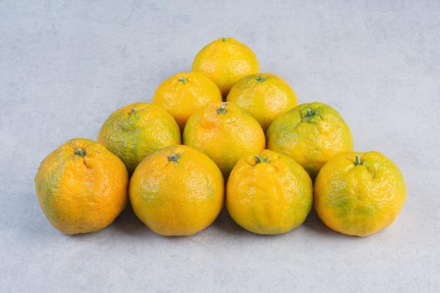 Pile of fresh tangerine on triangle shape . 