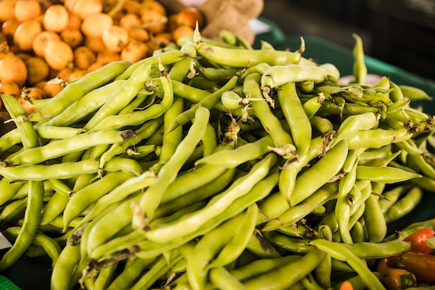 Pile of green peas vegetable at market stall