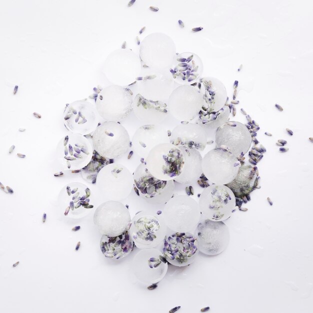 Pile of ice cubes with violet seeds