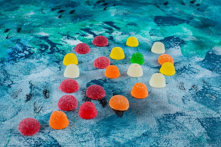 Free Photo a pile of marmalade candies, on the blue background. 