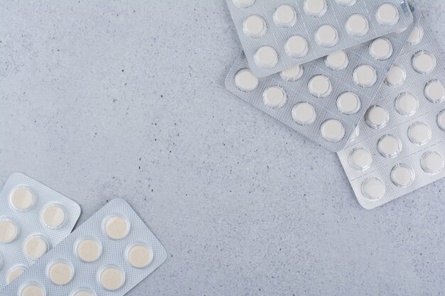 Pile of medical pills on marble background. 