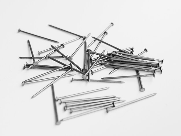 Pile of nails on white table 