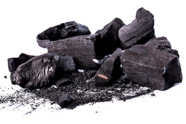 Pile of natural wood charcoal isolated on white background. activated carbon. Premium Photo