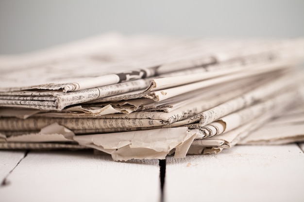 Pile of newspapers on a white table