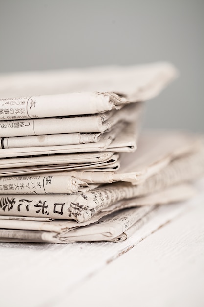 Pile of newspapers on a white table