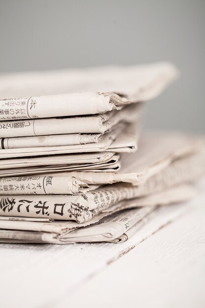 Pile of newspapers on a white table
