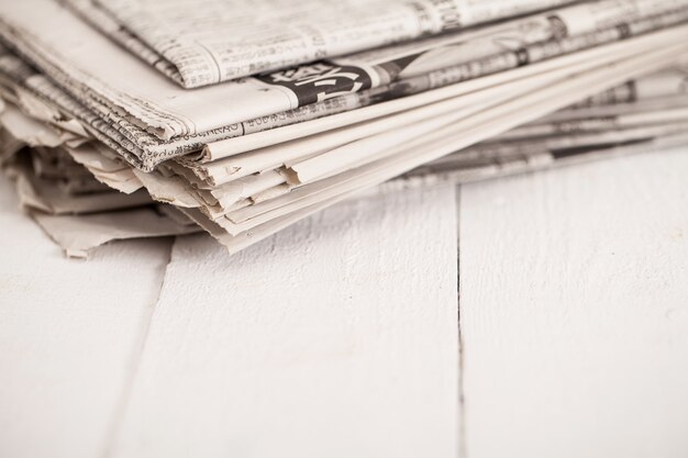 Pile of newspapers on a white table