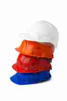 Free photo pile of plastic safety hardhats isolated on white background