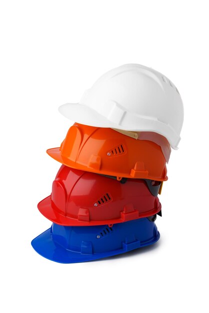 Pile of plastic safety hardhats isolated on white background