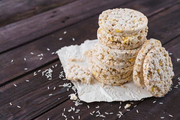 Pile of puffed rice cakes on brown wooden table