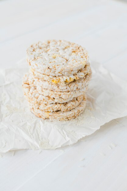 Pile of puffed rice cakes on white table