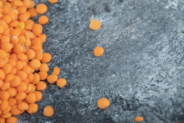 Pile of red lentils isolated on gray.