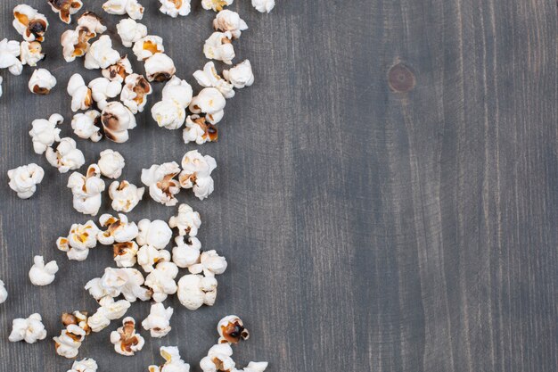 Pile of salted popcorn on wooden surface