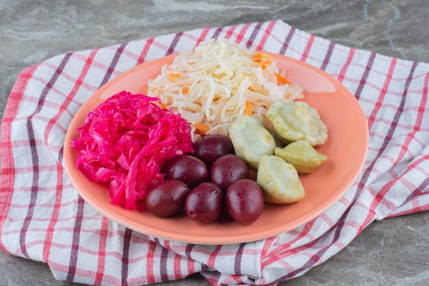 Pile of sauerkraut with palm and green patty pan. 