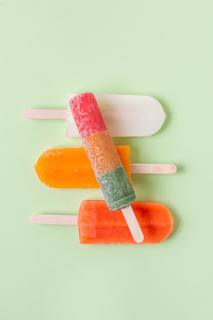 Pile of summer ice creams on sticks flat lay