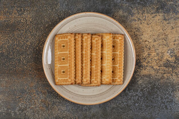 Pile of tasty biscuits on ceramic plate. 