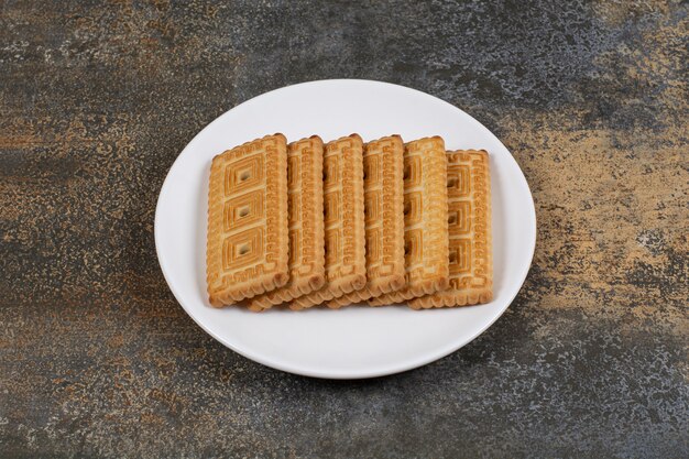 Pile of tasty biscuits on white plate. 
