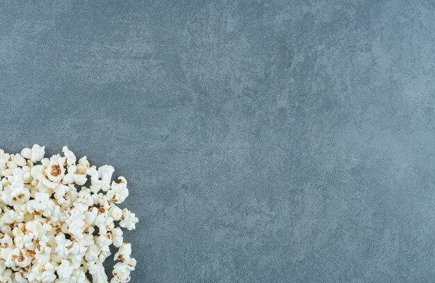 Pile of toothsome popcorn on marble background. High quality photo