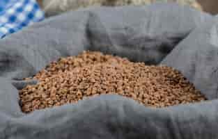 Free photo pile of uncooked buckwheat in gray cloth