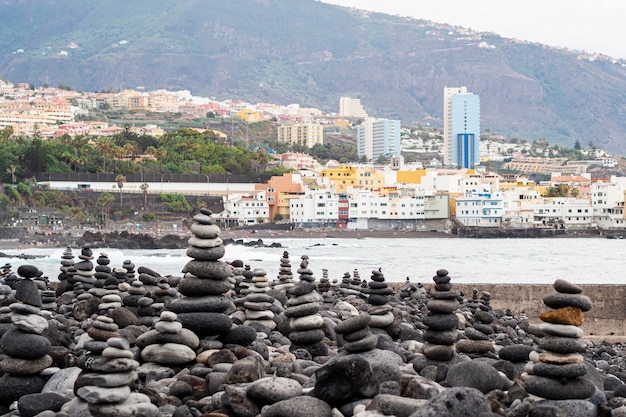 Piles of rocks with city on background