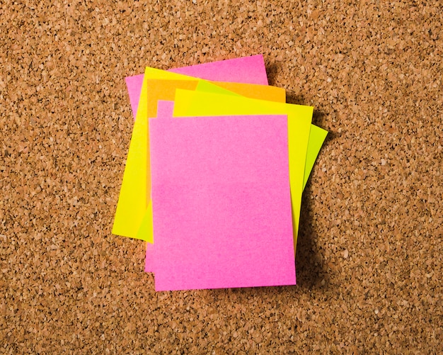 Piles of stick notes on cork board