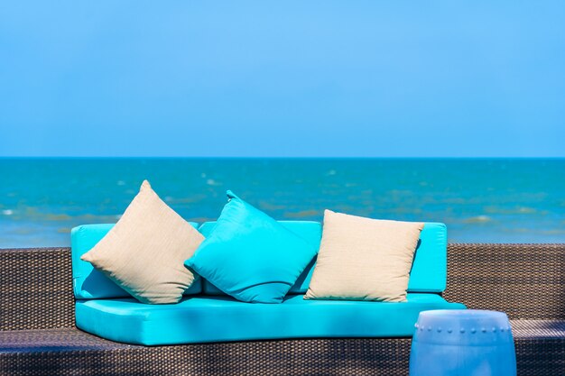 Pillow on sofa furniture decoration neary sea and beach on blue sky