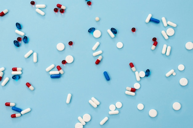 Pills arrangement on blue background