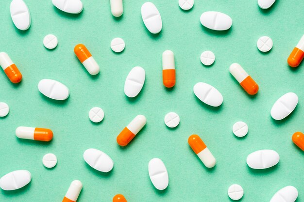 Pills arrangement on green background