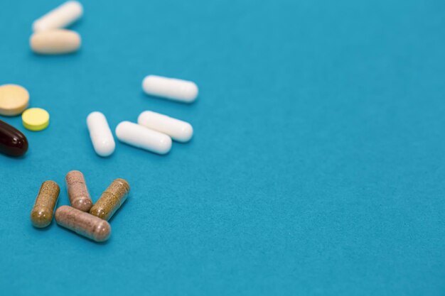Pills on a blue background closeup medicine concept