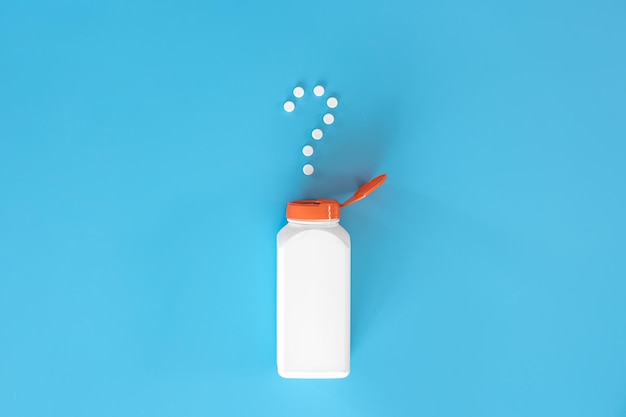 Pills on blue background flat lay medicine concept