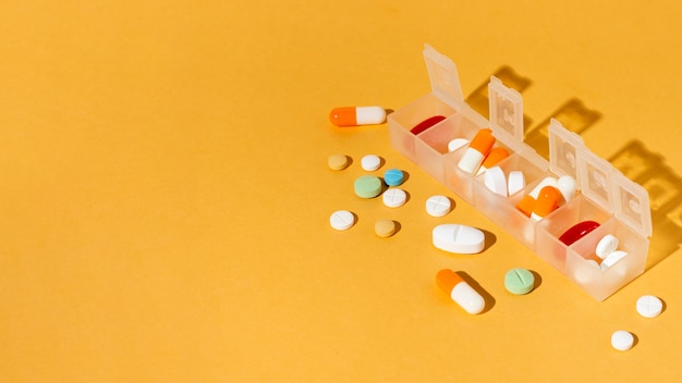 Pills box on yellow background