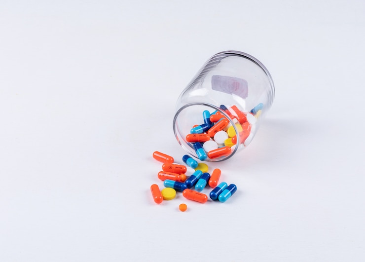Free Photo pills coming out of jar