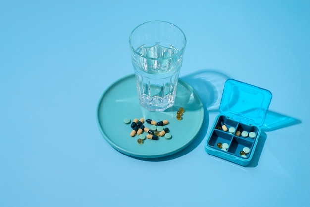 Pills container on blue background
