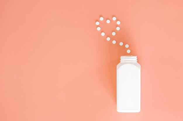 Pills on pink background flat lay medicine concept