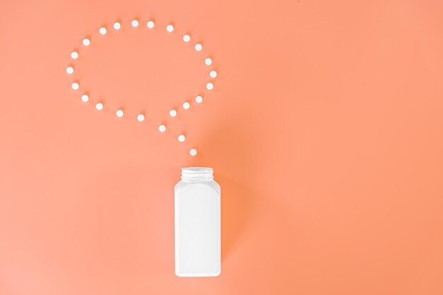 Pills on pink background flat lay medicine concept