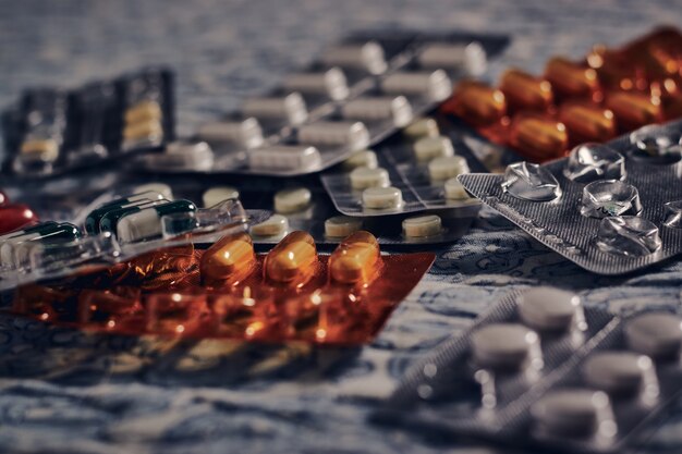 Pills and tablets on the fabric under the lights