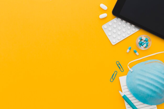 Pills with medical mask on desk