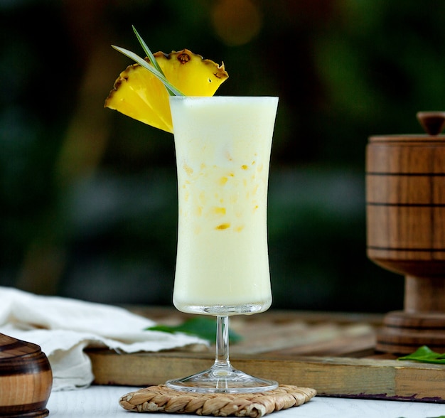 Pinacolada cocktail topped with ananas slice