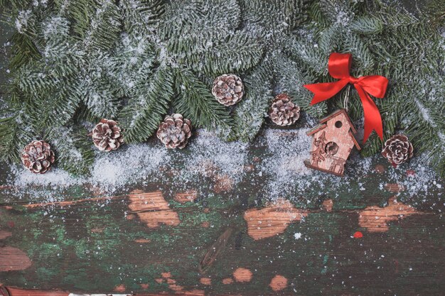 Pine cones on a christmas tree and a wooden house