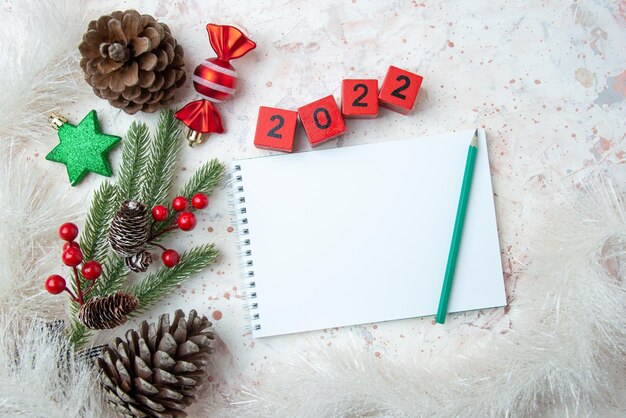 Pine nuts with red numbers and notepad as a new year concept on a blurred background