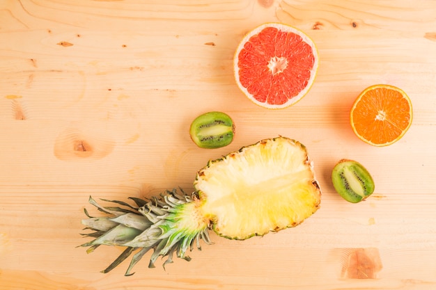 Pineapple and citrus fruits on wooden table