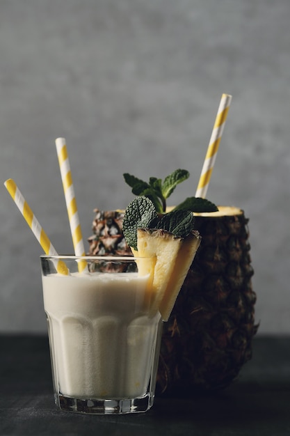 Pineapple cocktail with straw. Tropical drink