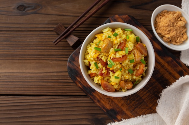 Pineapple fried rice on wooden table