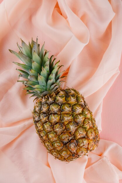 Pineapple on pink and textile surface