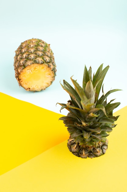 Pineapple ripe fresh mellow juicy sliced on the ice-blue and yellow floor