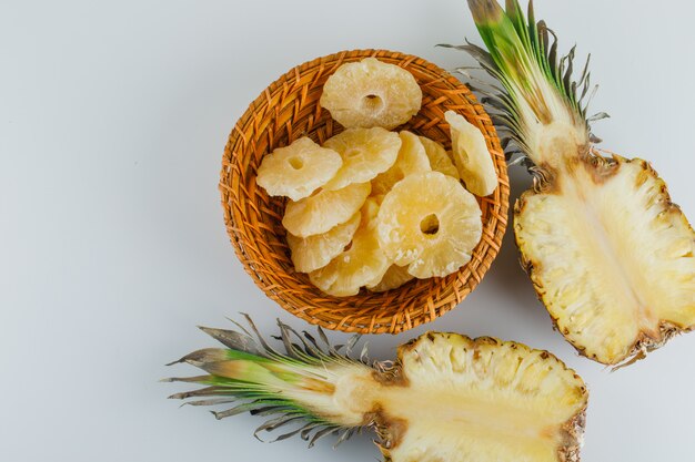 Pineapple slices with candied rings on white surface